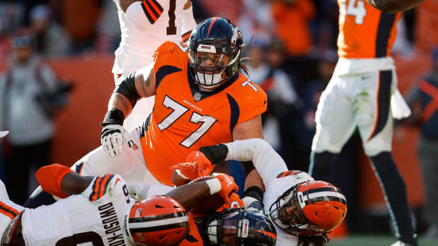 Nov 26, 2023; Denver, Colorado, USA; Denver Broncos running back Samaje Perine (25) scores a touchdown against Cleveland Browns linebacker Jeremiah Owusu-Koramoah (6) and linebacker Sione Takitaki (44) after being pushed into the end zone by guard Quinn Meinerz (77) in the first quarter at Empower Field at Mile High. Mandatory Credit: Isaiah J. Downing-USA TODAY Sports  